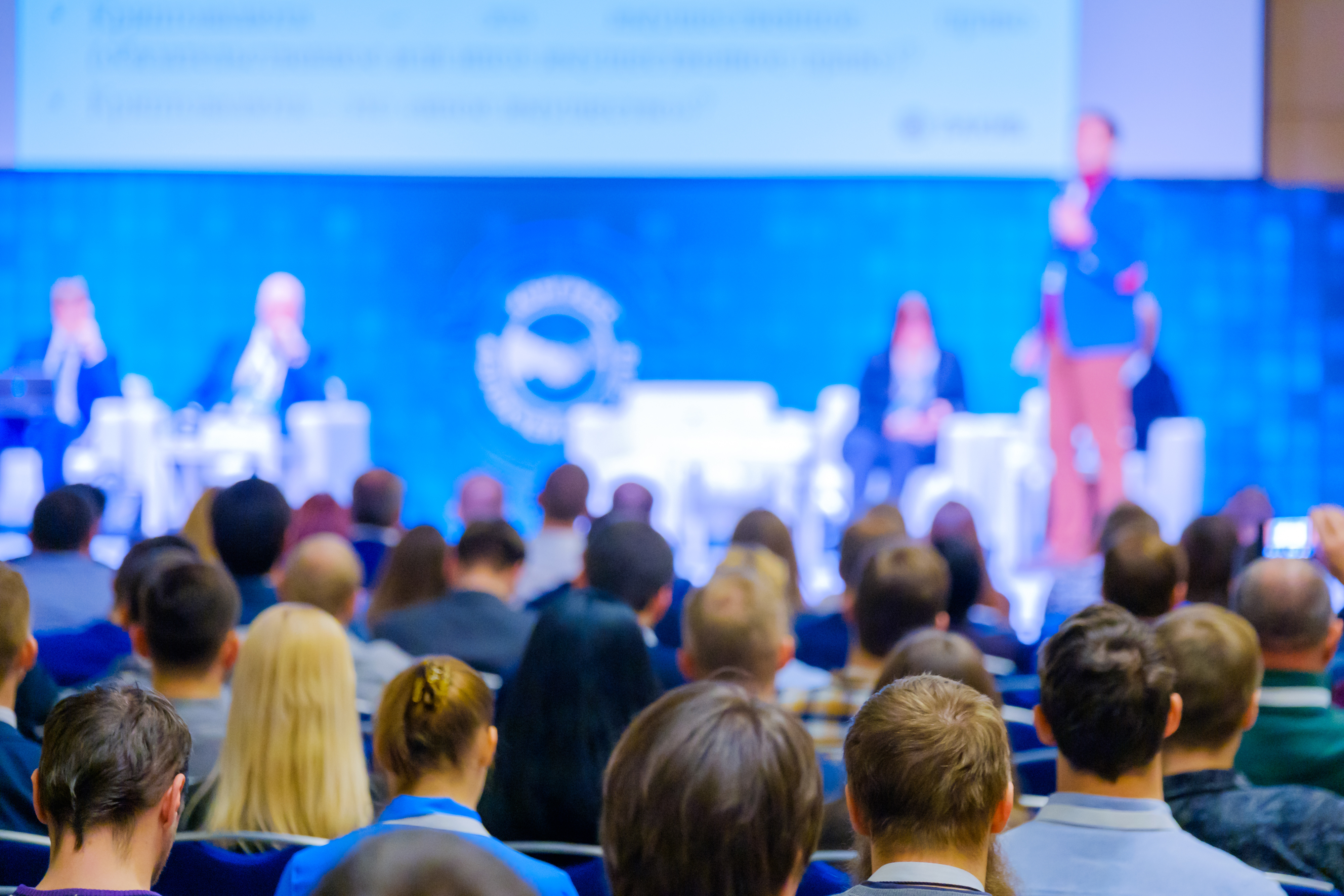 People attend business conference in the congress hall